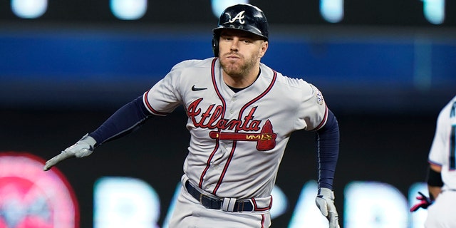 Atlanta Braves' Freddie Freeman rounds second base as he gets a triple during the fourth inning of a baseball game against the Miami Marlins, Wednesday, Aug. 18, 2021, in Miami. (Associated Press)