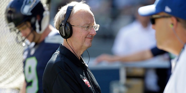 FILE - John "The Professor" Clayton, an NFL football writer and reporter for ESPN, stands on the sideline during an NFL football game between the Seattle Seahawks and the San Francisco 49ers, Sunday, Sept. 25, 2016, in Seattle. Clayton died Friday, March 18, 2022, following a short illness. He was 67. 