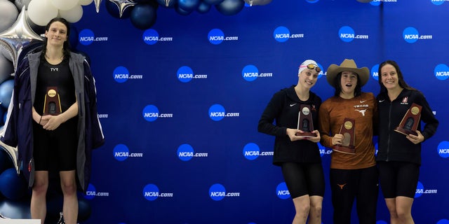 Transgender athlete Lia Thomas, left, of the University of Pennsylvania, stands on the podium after winning the 500-yard freestyle as other medalists – from second left, Emma Weyant, Erica Sullivan and Brooke Forde – pose for a photo at the NCAA Division I Women's Swimming and Diving Championships, March 17, 2022 in Atlanta. (Getty Images)
