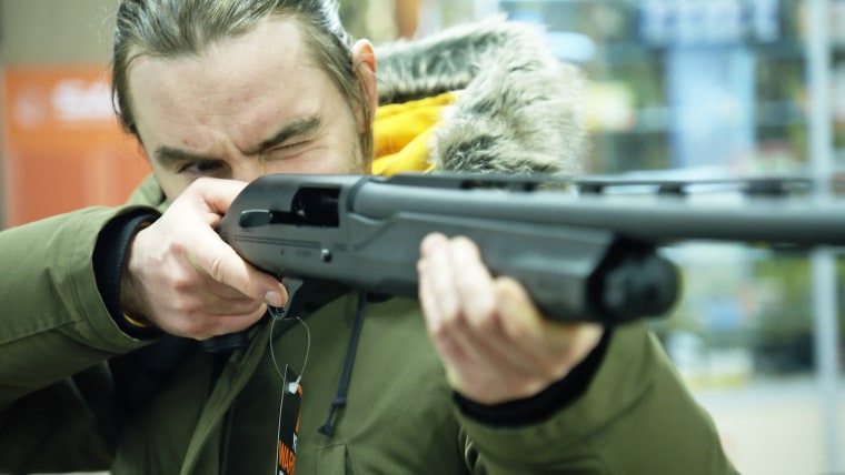 “I hope I don’t have to kill the Russian soldiers but if it will be needed, I’ll do it,” said Vasyl Slotylo, pictured examining a gun. 