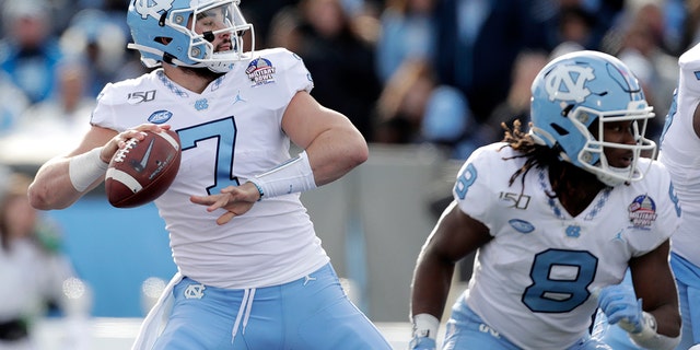 North Carolina quarterback Sam Howell throws a touchdown pass to wide receiver Dyami Brown during the first half of the Military Bowl NCAA college football game against Temple, Friday, Dec. 27, 2019, in Annapolis, Maryland. (AP Photo/Julio Cortez, File)