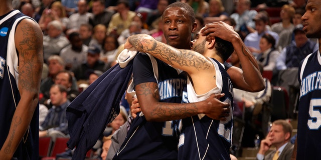 St. Peter's College Wesley Jenkins (15) and Nick Leon (21) upset after losing game to Purdue at United Center, Chicago