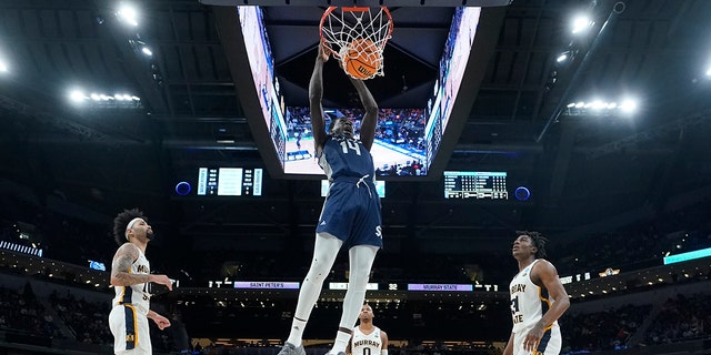 Saint Peter's Hassan Drame (14) dunks during the second half of a college basketball game against Murray State in the second round of the NCAA tournament, Saturday, March 19, 2022, in Indianapolis. 