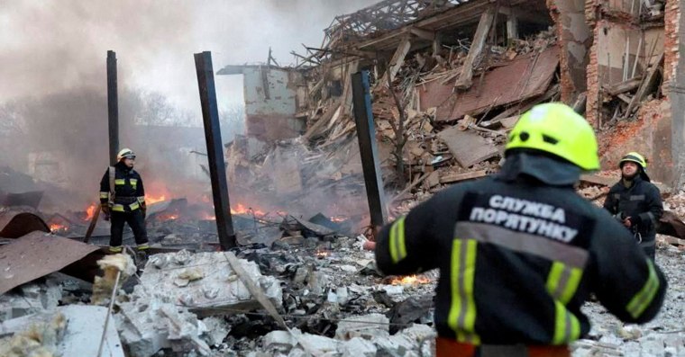 Image: Rescuers work among remains of buildings damaged by an airstrike, as Russia's attack on Ukraine continues, in Dnipro, Ukraine.