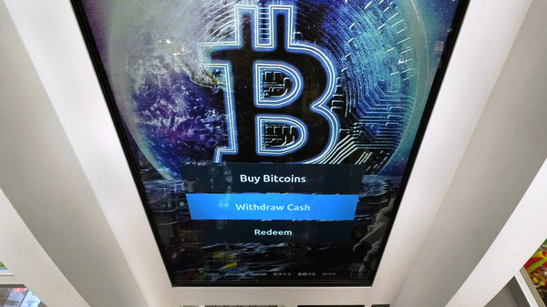 Bitcoin logo appears on the display screen of a cryptocurrency ATM at the Smoker