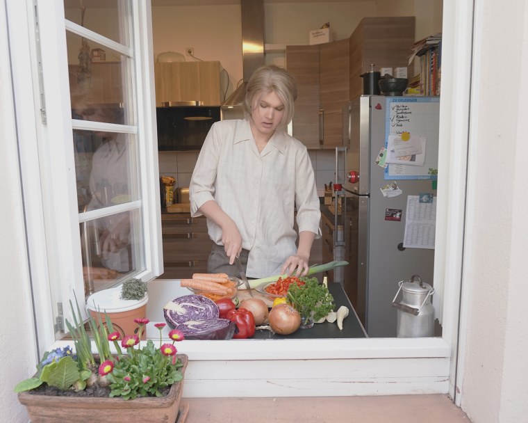 Zi Faámelu prepares food in her current home in Germany. 