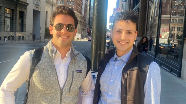 Faris Ajluni (right) land Jose Nazario pose in their vests in downtown San Francisco.