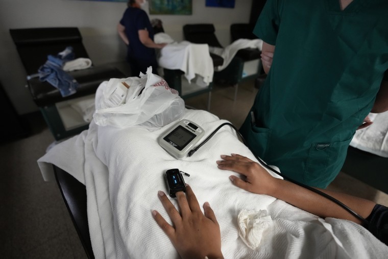 A medical student, right, and nurse, rear, monitor women as they rest before and after getting abortions, at Hope Medical Group for Women, in Shreveport, La., on Oct . 9, 2021.