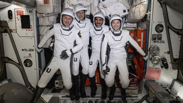 In this photo made available by NASA, commercial crew astronauts, from left, European Space Agency astronaut Matthias Maurer, and NASA astronauts Tom Marshburn, Raja Chari, and Kayla Barron, pose for a photo in their Dragon spacesuits during a fit check aboard the International Space Station