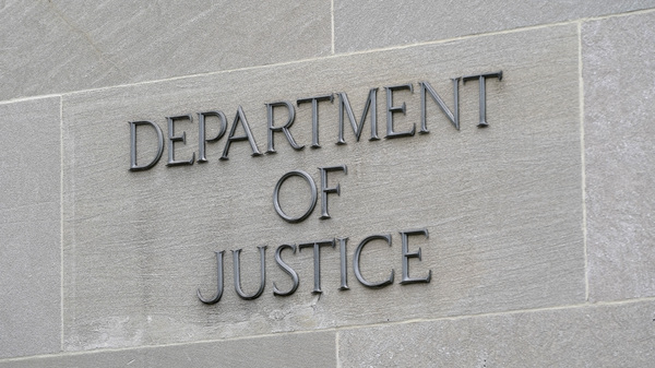 A sign marks the facade of the Robert F. Kennedy Department of Justice Building in Washington, D.C. on May 5. A group of senators are asking the DOJ why the agency has failed to file reports on on the federal government