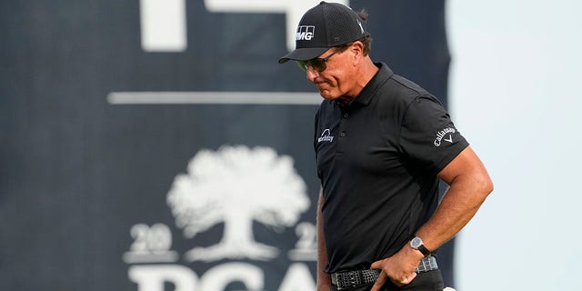FILE - Phil Mickelson walks off the 14th green after missing a birdie putt during the third round at the PGA Championship golf tournament on the Ocean Course, Saturday, May 22, 2021, in Kiawah Island, S.C.