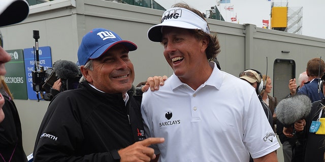 Phil Mickelson of the United States is congratulated by Fred Couples of the United States after winning the final round of the 142nd Open Championship at Muirfield on July 21, 2013 in Gullane, Scotland.   