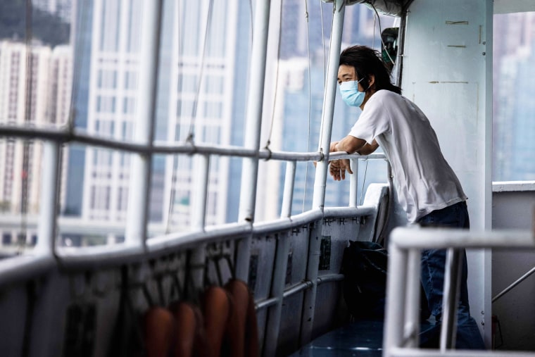 A man looks out from a ferry in Hong Kong