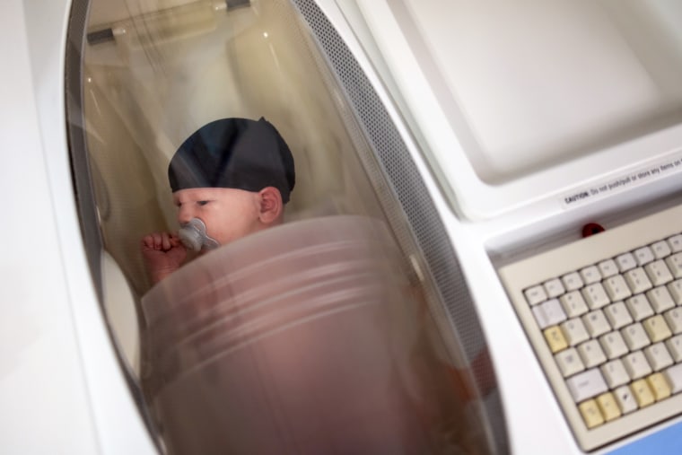 Researchers calculate two-week-old Jameson Hardee’s body fat percentage in a machine called a Pea Pod. Jameson’s mother, Julie Hardee, works in the lab, and volunteered Jameson to demonstrate how measurements are taken.
