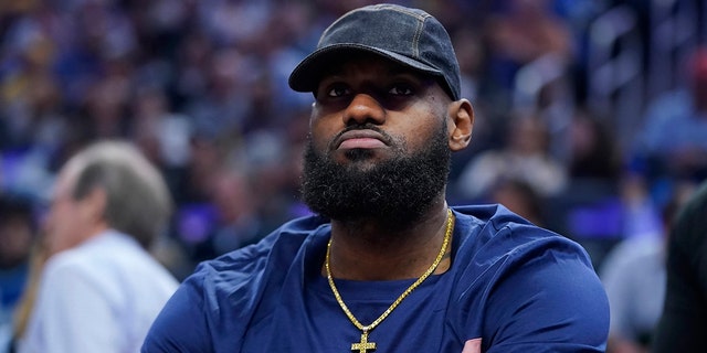 Los Angeles Lakers' LeBron James sits on the bench during the first half of the team's NBA basketball game against the Golden State Warriors in San Francisco, Thursday, April 7, 2022.