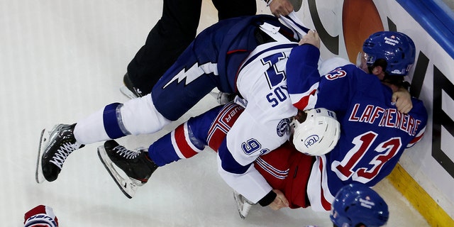 Steven Stamkos #91 of the Tampa Bay Lightning fights with Alexis Lafrenière #13 of the New York Rangers at the end of the third period in Game Five of the Eastern Conference Final of the 2022 Stanley Cup Playoffs at Madison Square Garden on June 09, 2022 in New York City.