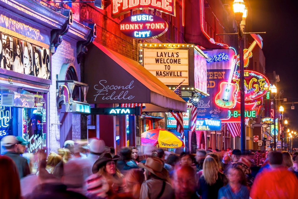 party on a weekend in nashville neon signs and people