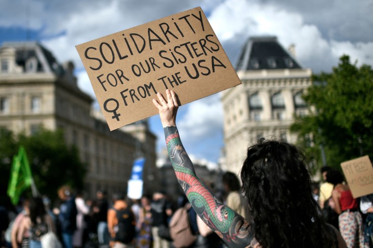 Image: A protestor holds a sign during a rally in support of worldwide abortion rights in Paris, after the U.S. Supreme Court's overturned Roe v. Wade, on June 24, 2022.