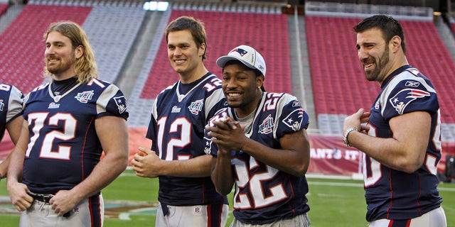 New England Patriots cornerback Asante Samuel (22) finds it a little chilly on the field with offensive tackle Matt Light (72), quarterback Tom Brady (12) and linebacker Mike Vrabel during Media Day for Super Bowl XLII at the University of Phoenix Stadium in Glendale, Ariz., on Jan. 29, 2008.