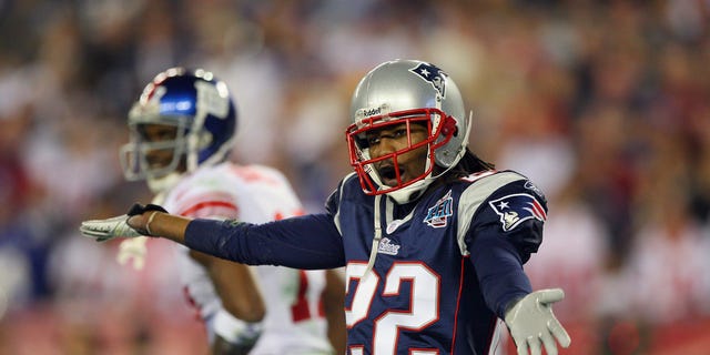 Cornerback Asante Samuel of the New England Patriots celebrates after breaking up a pass thrown to New York Giants wide receiver Plaxico Burress, background, during the third quarter of Super Bowl XLII at the University of Phoenix Stadium in Glendale, Ariz., on Feb. 3, 2008.