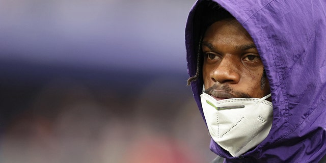Lamar Jackson #8 of the Baltimore Ravens looks on from the sidelines in the third quarter of the game against the Los Angeles Rams at M&amp;T Bank Stadium on January 02, 2022 in Baltimore, Maryland.