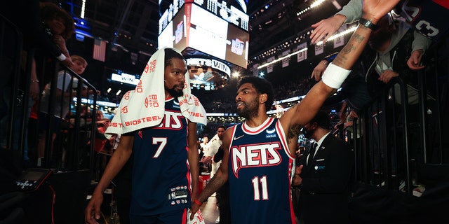 Kevin Durant and Kyrie Irving walk off the court after the Cleveland Cavaliers game on April 8, 2022, at Barclays Center in Brooklyn.