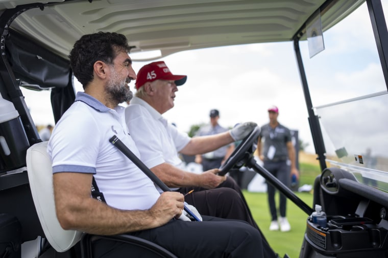Image:Former president Donald Trump drives a golf cart with Yasir Al-Rumayyan, head of the sovereign wealth fund of Saudi Arabia at the Trump National Golf Club in Bedminster, N.J. on July 28, 2022.