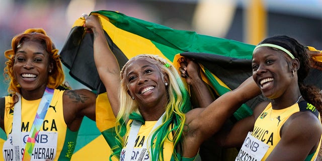 Shelly-Ann Fraser-Pryce, of Jamaica, center, reacts after winning Gold in the final in the women's 100-meter run at the World Athletics Championships on Sunday, July 17, 2022, in Eugene, Ore. 