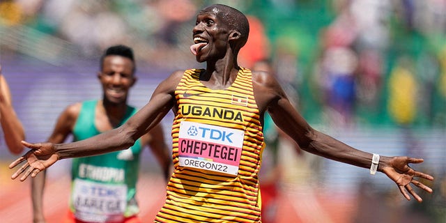 Joshua Cheptegei, of Uganda, reacts to winning the men's 10000-meter run final at the World Athletics Championships on Sunday, July 17, 2022, in Eugene, Ore. 