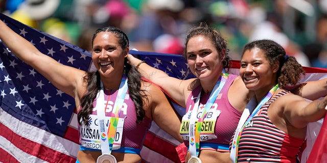 Gold medalist Brooke Andersen, of the United States, center, stands with silver medalist Camryn Rogers, of Canada, right, and bronze medalist Janee' Kassanavoid, of the United States, after the women's hammer throw final at the World Athletics Championships on Sunday, July 17, 2022, in Eugene, Ore. 