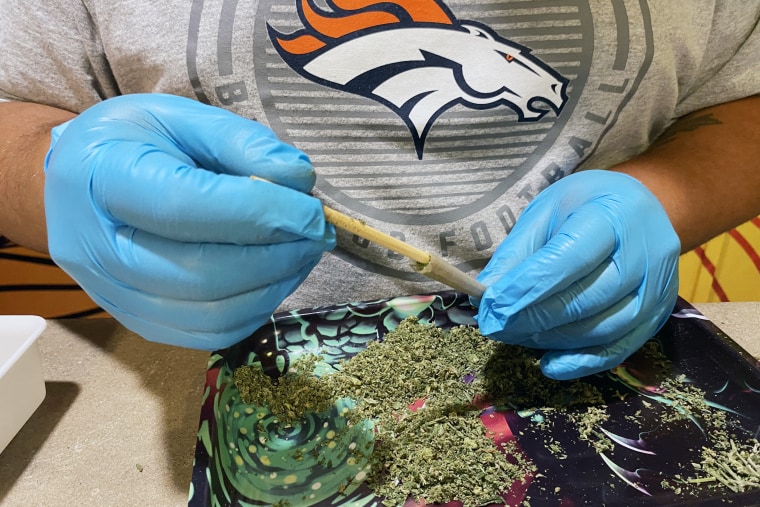 Koby Morrisette, a “budtender” at the No Worries dispensary, prepares a joint.