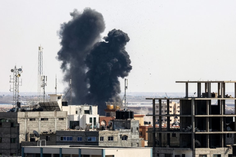 Smoke billows from a building struck during an Israeli air strike in Rafah in the southern Gaza Strip on Aug. 7, 2022.