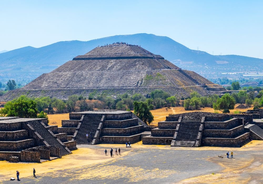 The Sun Pyramid and minor temples with some tourists walking around in Teotihuacan, Mexico City, Mexico.