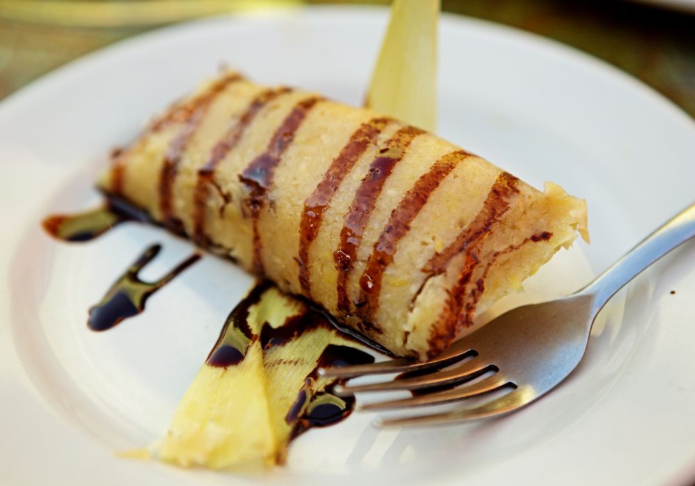 Chocolate tamales served on a white ceramic plate in the city of Campeche.