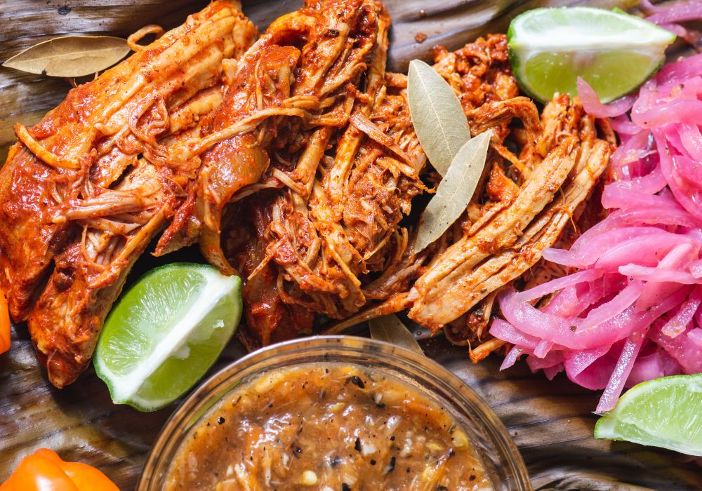 Cochinita Pibil served with Yucatan habanero sauce and pickled onions.