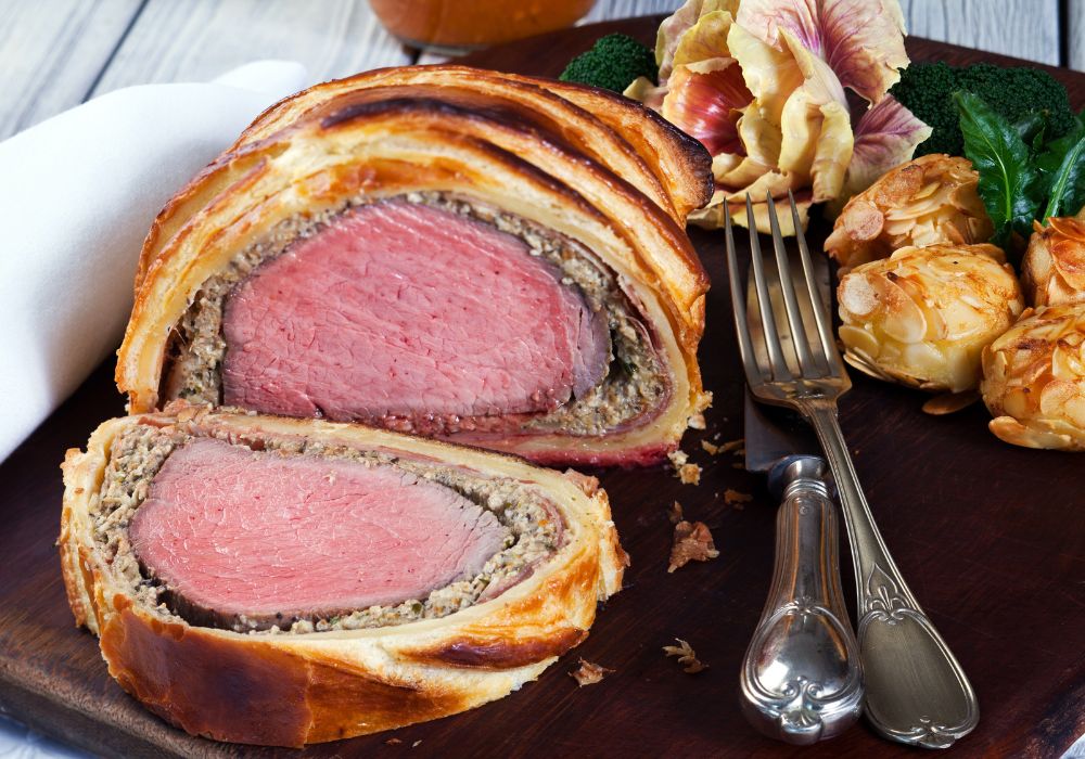A delicious beef wellington on a cutting board.