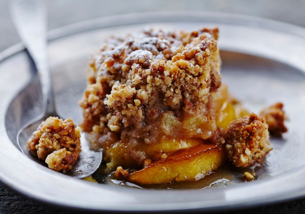 Fresh apple crumble on a ceramic bowl.