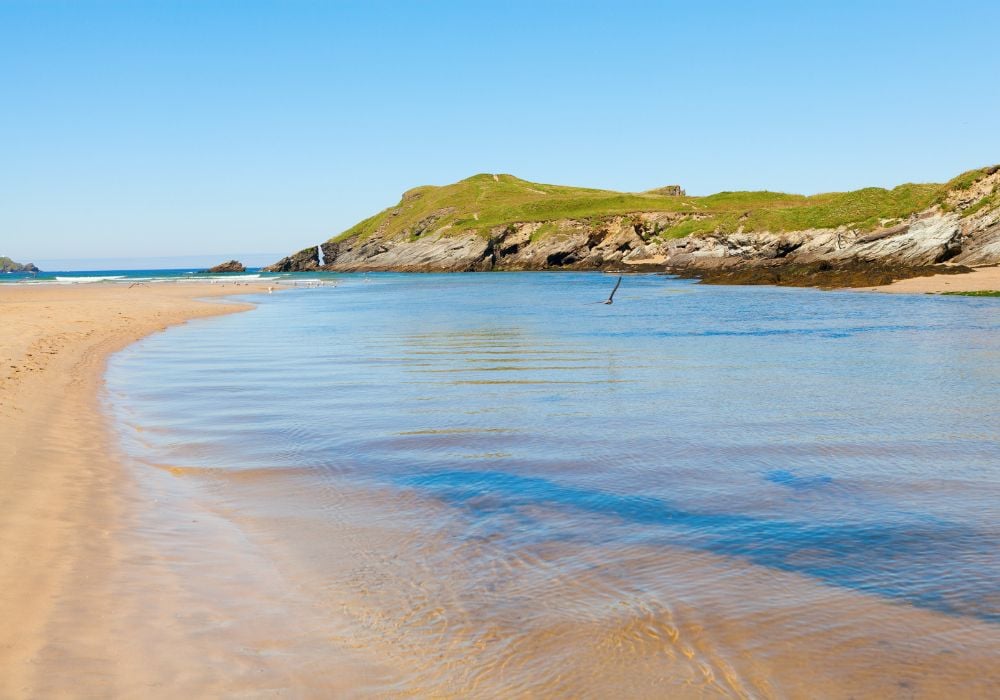 Beautiful blue sky over the stunning Porth beach in Newquay, Cornwall.