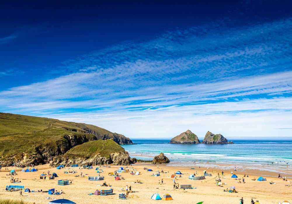 Beautiful blue sky over the stunning Hollywell beach in Newquay, Cornwall.