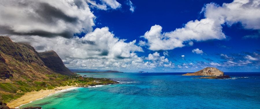 oahu island in hawaii with mountains blue water and clear sky with clouds
