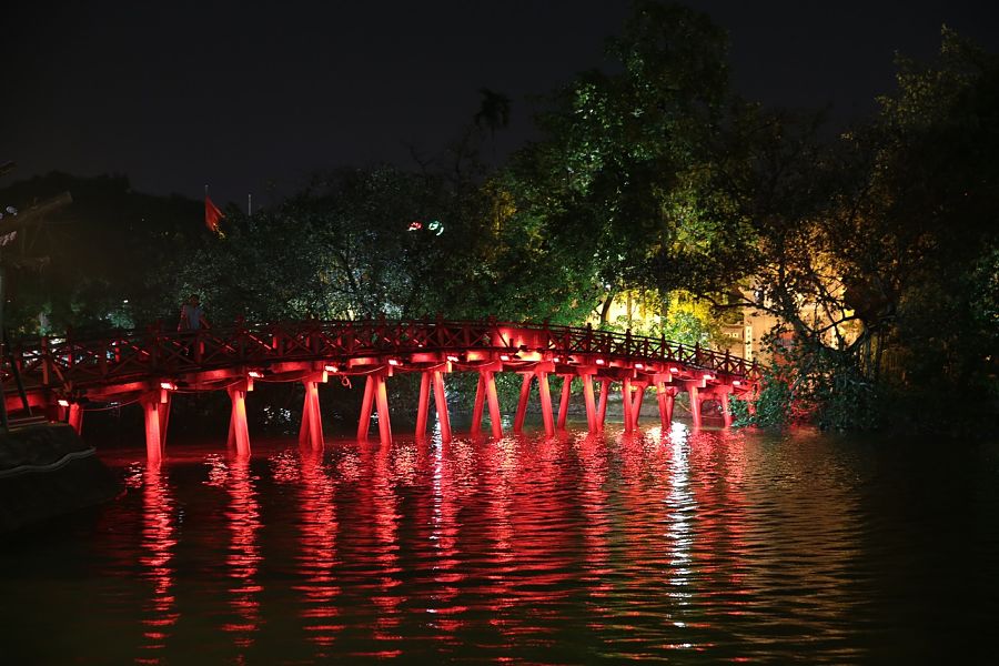 A footbridge lit up in red in Hanoi, a top choice for where to go in Vietnam