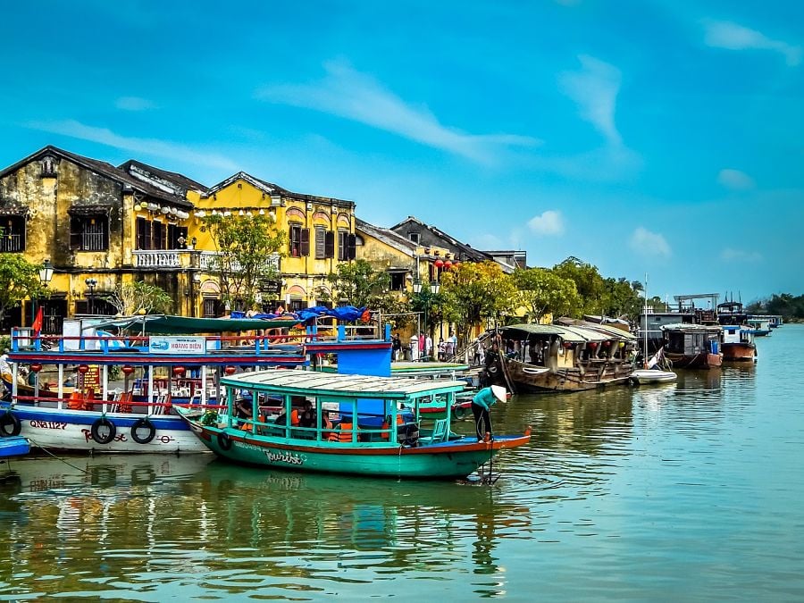 Boats and colonial era buildings along the waterfront in Hoi An 