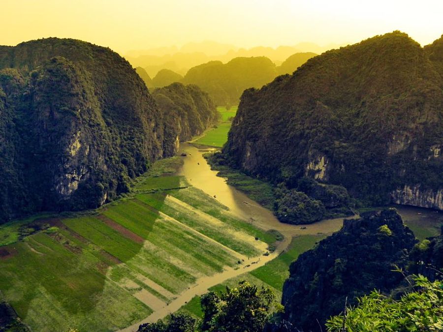 River winding through mountains of tall cliffs in Ninh Binh. 