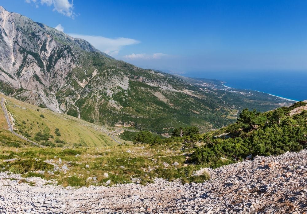 Summer Llogara National Park pass view with serpentine road and Ionian Sea coast in Albania.