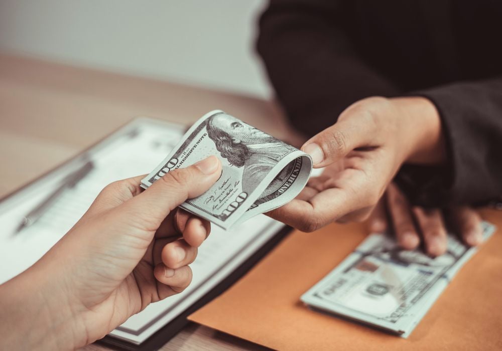 Man handling out a salary to a pet sitter.