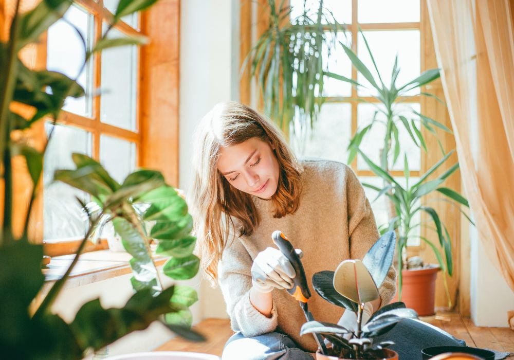 Candid portait of young woman planting and she's using a shovel.