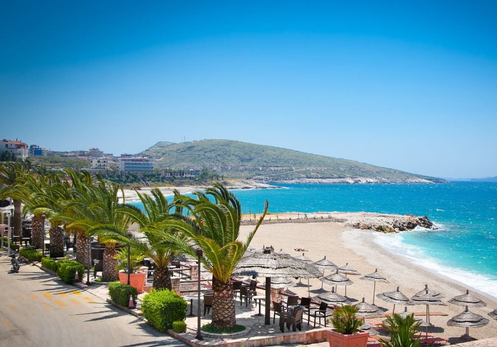 Deck chairs and sunshade umbrellas on Sarande's lovely beach in Albania.