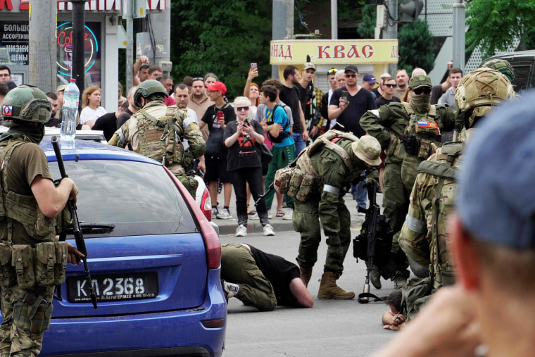 Members of Wagner group detain a man in the city of Rostov-on-Don