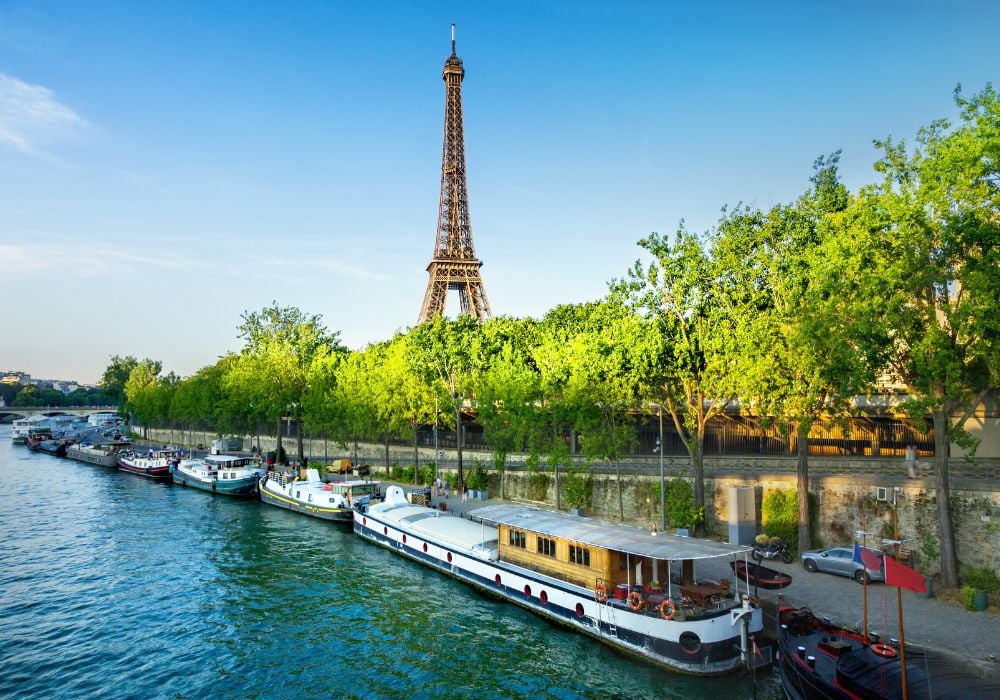 A beautiful scenic view of Eiffel Tower from afar along the river
