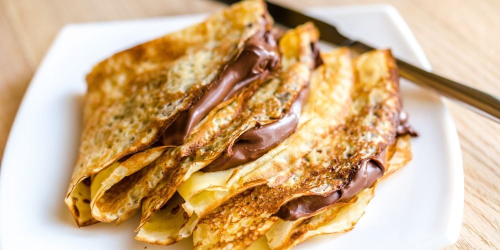 A plate of crêpes filled with Nutella